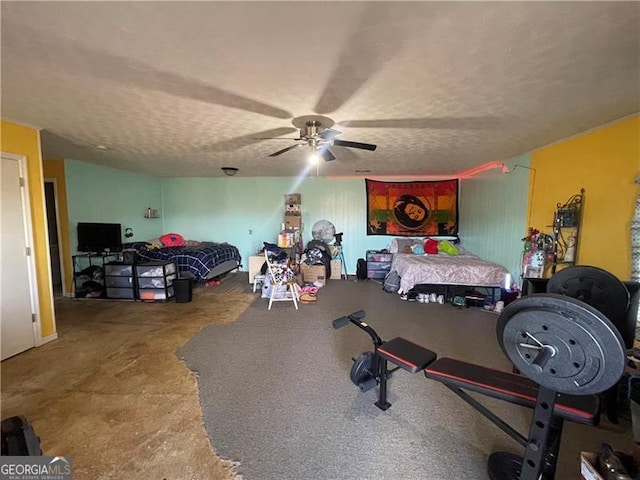 bedroom with ceiling fan and a textured ceiling