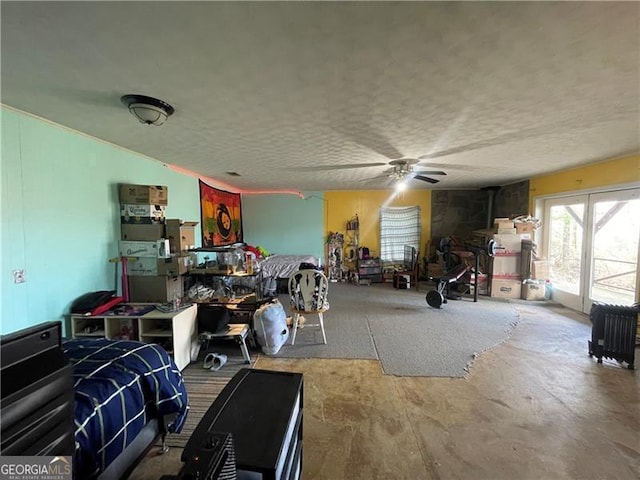 misc room with ceiling fan and a textured ceiling