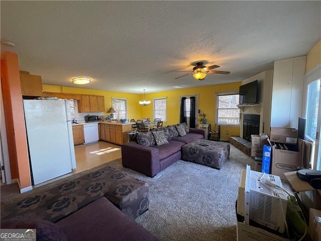 living room featuring ceiling fan and a textured ceiling