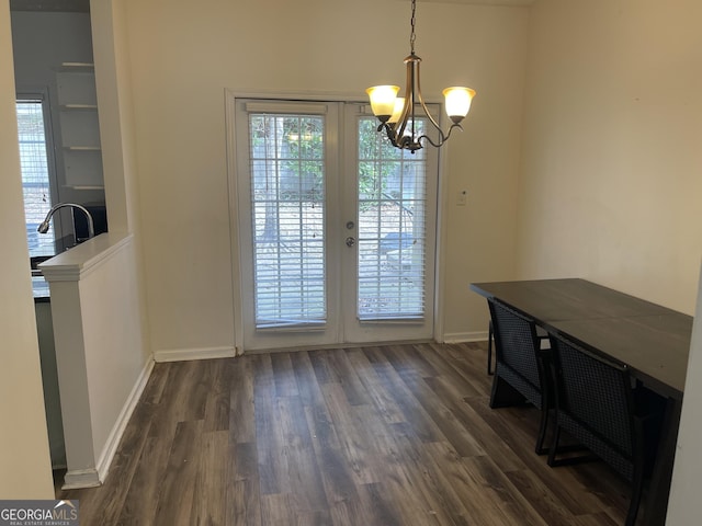 dining room with an inviting chandelier, dark hardwood / wood-style floors, and french doors