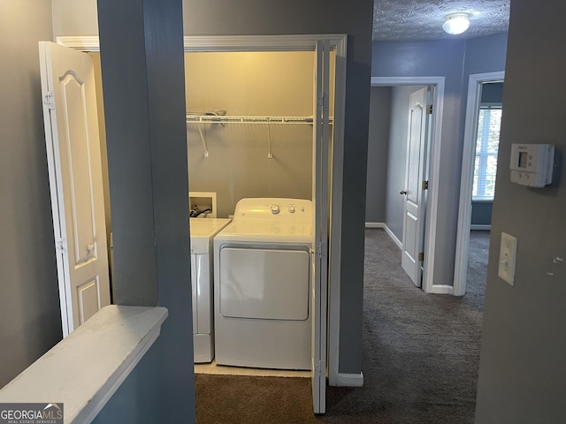 laundry area with washing machine and dryer, a textured ceiling, and dark colored carpet