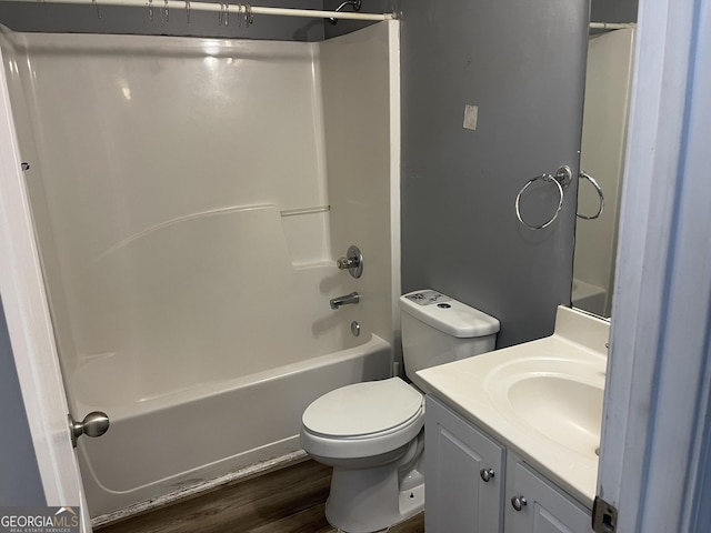 full bathroom featuring vanity, wood-type flooring, tub / shower combination, and toilet