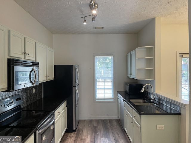 kitchen with white cabinetry, sink, dark wood-type flooring, and stainless steel appliances