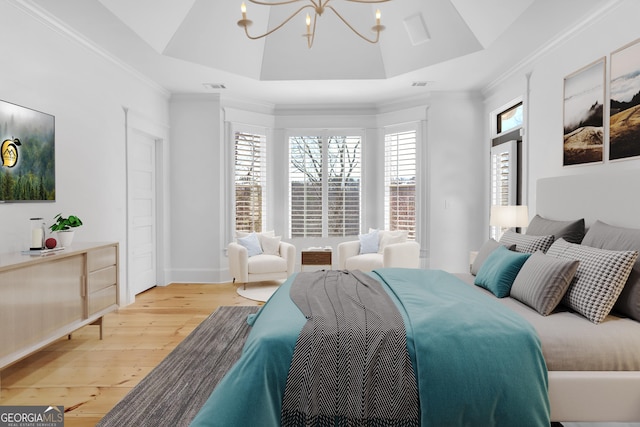 bedroom with wood-type flooring, a tray ceiling, and multiple windows