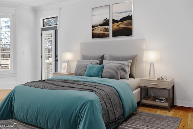 bedroom featuring light hardwood / wood-style flooring and ornamental molding