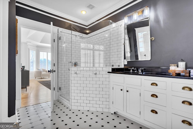 bathroom featuring crown molding, vanity, and a shower with shower door