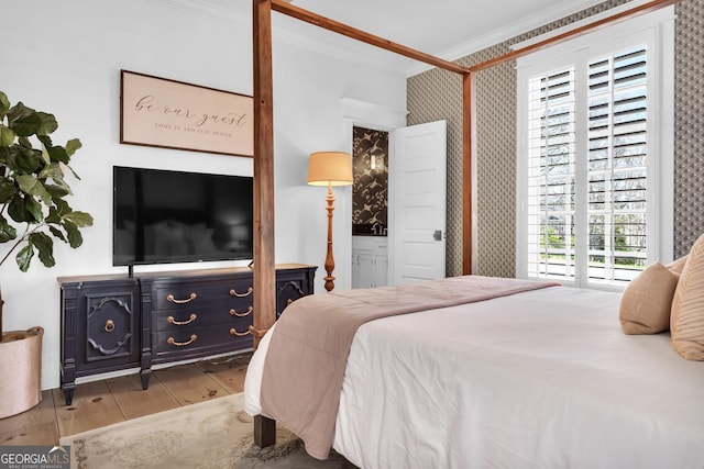 bedroom with crown molding and light wood-type flooring