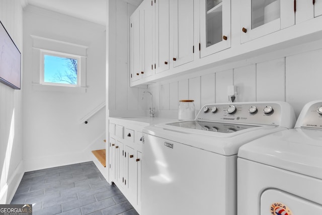 washroom featuring cabinets, washer and dryer, and sink