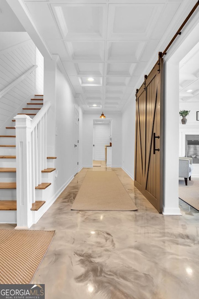 hallway with a barn door and coffered ceiling