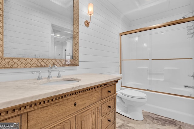 full bathroom featuring wooden walls, vanity, toilet, and combined bath / shower with glass door