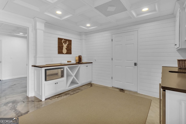 bar with coffered ceiling and white cabinets