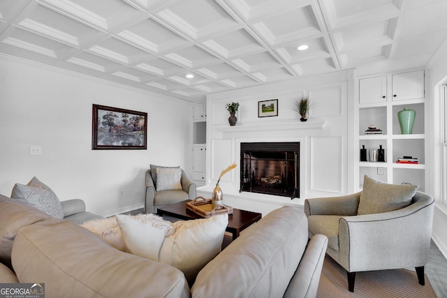 living room with coffered ceiling, built in shelves, and beam ceiling