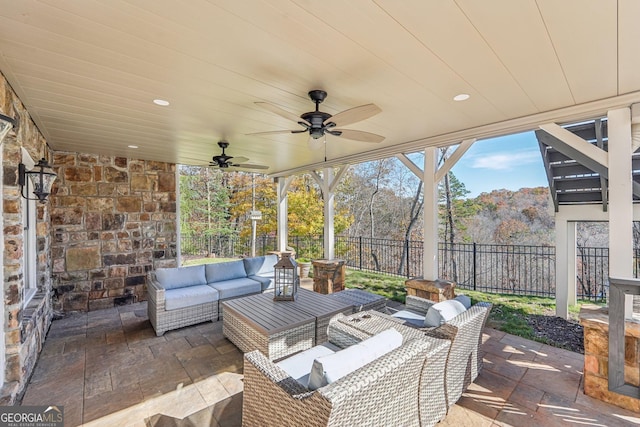 view of patio with an outdoor living space and ceiling fan