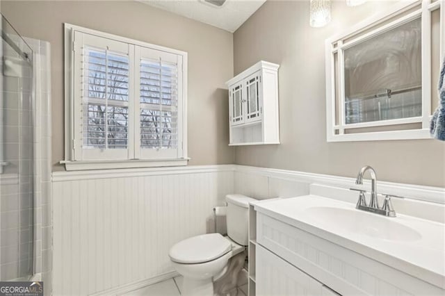 bathroom with tile patterned flooring, vanity, and toilet