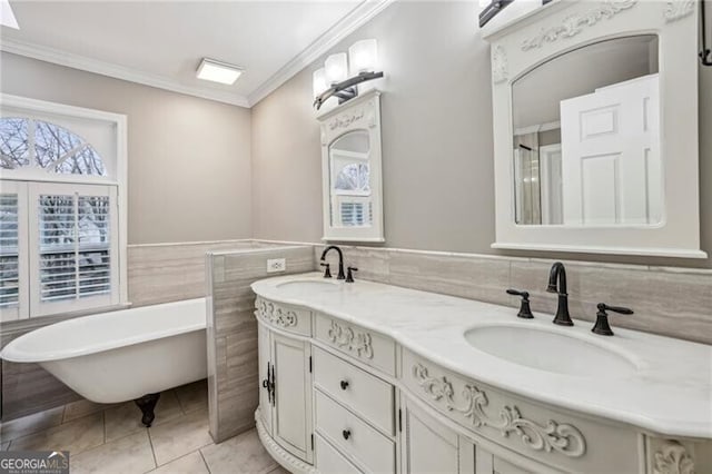 bathroom with crown molding, tile walls, vanity, a tub, and tile patterned flooring