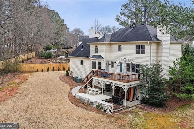 back of house with a wooden deck, central AC, and a patio area