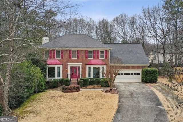 colonial inspired home featuring a garage