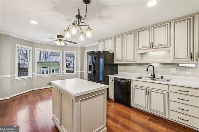 kitchen featuring sink, crown molding, cream cabinets, and black appliances