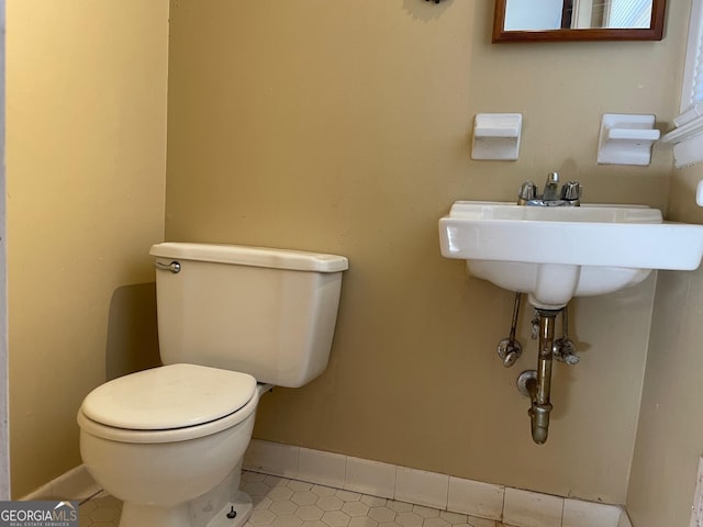 bathroom featuring tile patterned flooring and toilet