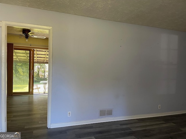 unfurnished room featuring ceiling fan, dark hardwood / wood-style flooring, and a textured ceiling