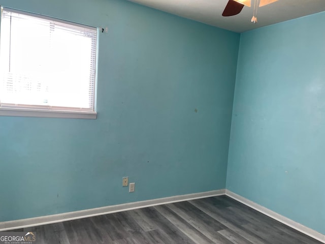 empty room featuring ceiling fan and dark hardwood / wood-style flooring