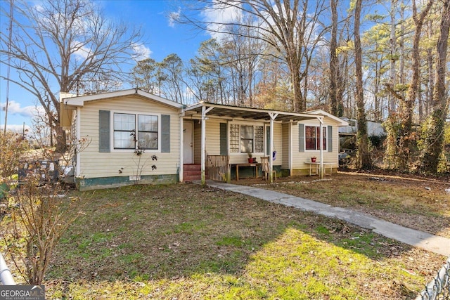 bungalow-style house with a front yard