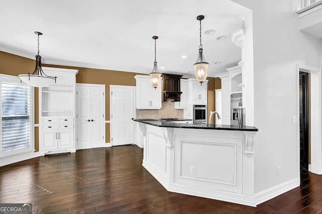 kitchen with white cabinetry, dark hardwood / wood-style flooring, pendant lighting, stainless steel appliances, and decorative backsplash