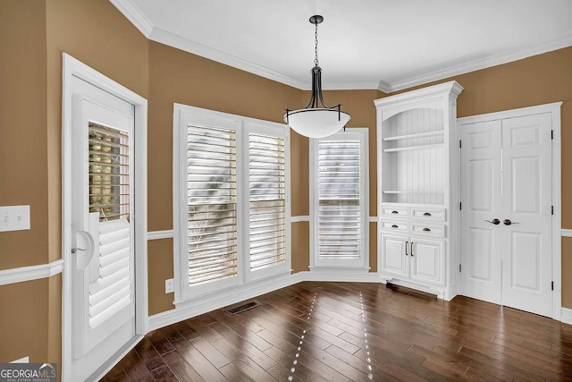 unfurnished dining area featuring dark hardwood / wood-style flooring and crown molding