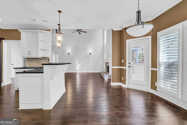 kitchen featuring white cabinetry, dark hardwood / wood-style floors, decorative light fixtures, and a kitchen island