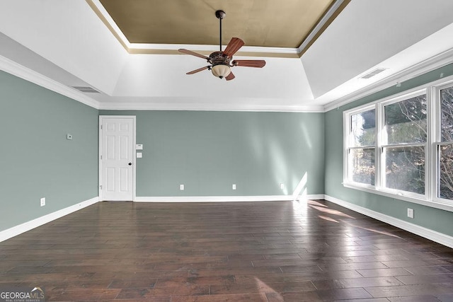 interior space featuring ornamental molding, dark hardwood / wood-style floors, and a raised ceiling