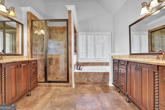 bathroom featuring vanity, a wealth of natural light, shower with separate bathtub, and vaulted ceiling