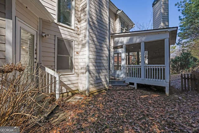 view of side of home with a sunroom