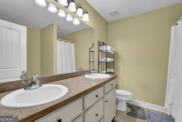 full bath with visible vents, a sink, toilet, and double vanity