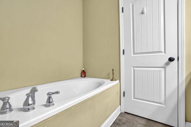 full bath featuring a garden tub and tile patterned floors