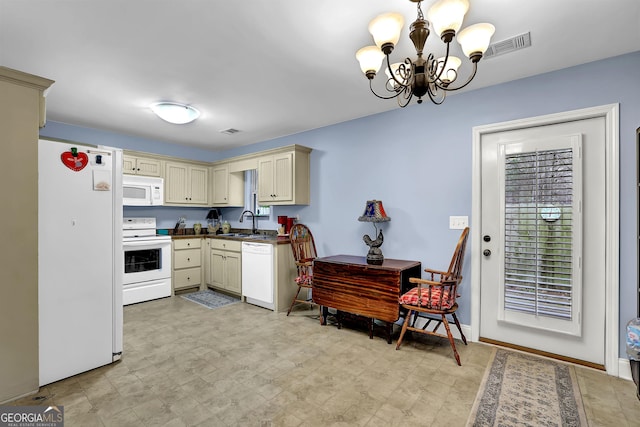 kitchen featuring white appliances, a sink, visible vents, cream cabinetry, and dark countertops