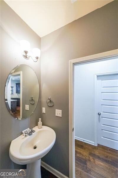 bathroom with hardwood / wood-style floors and sink