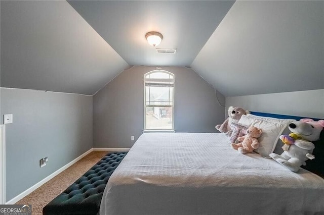 bedroom featuring vaulted ceiling and carpet floors