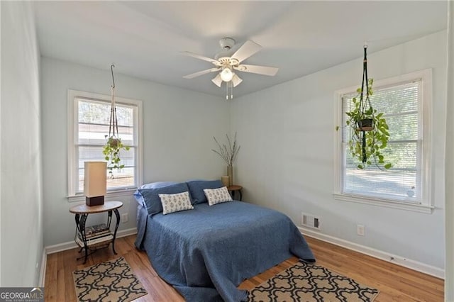 bedroom featuring hardwood / wood-style floors and ceiling fan