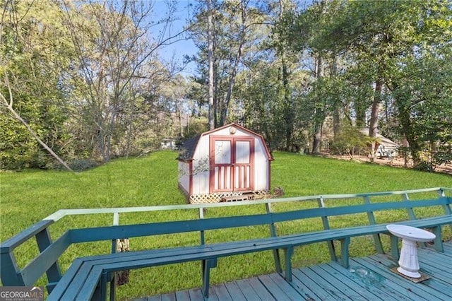 wooden terrace with a storage shed and a yard