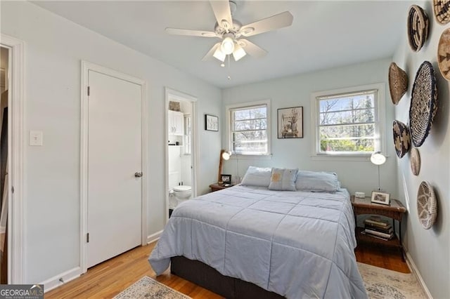 bedroom featuring ceiling fan, connected bathroom, and light wood-type flooring