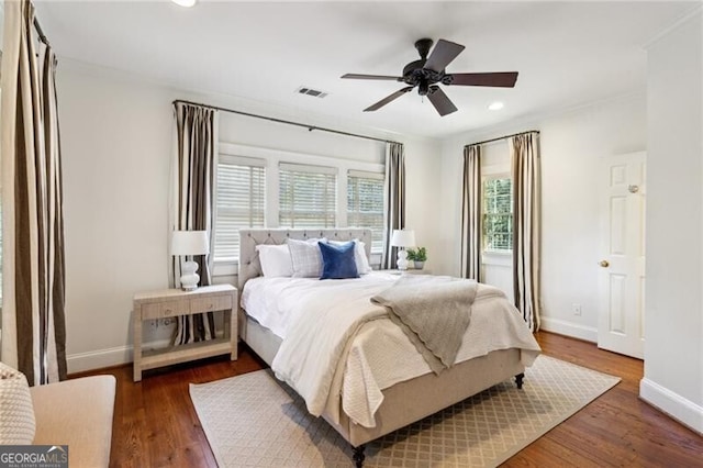 bedroom with ceiling fan and dark hardwood / wood-style flooring