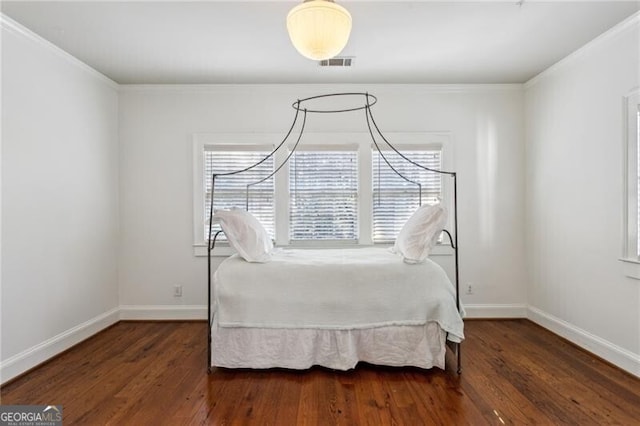 unfurnished bedroom with ornamental molding and dark hardwood / wood-style floors