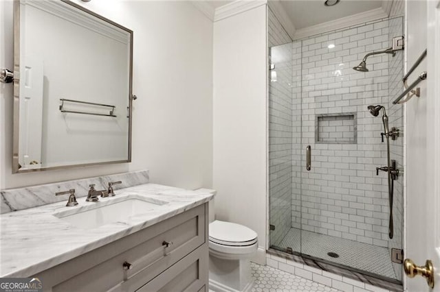 bathroom featuring crown molding, tile patterned flooring, vanity, a shower with shower door, and toilet