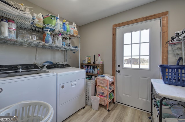 clothes washing area featuring laundry area, separate washer and dryer, and light wood-style floors