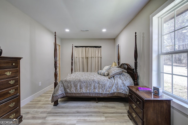 bedroom featuring recessed lighting, visible vents, light wood finished floors, and baseboards