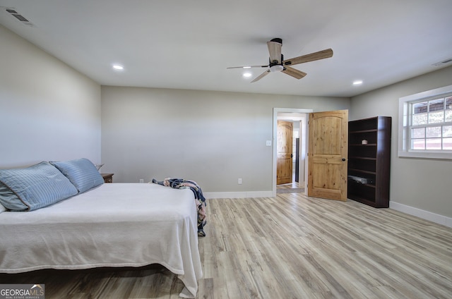 bedroom with light wood-style floors, recessed lighting, visible vents, and baseboards