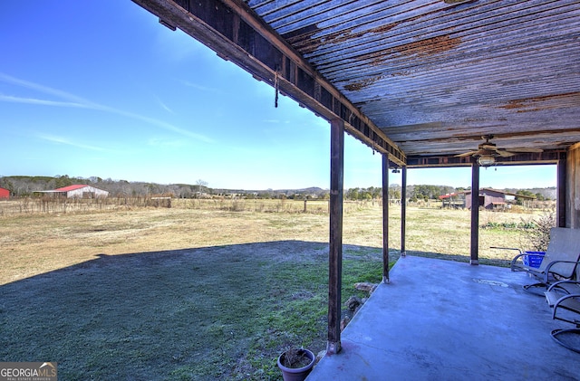 view of yard featuring a ceiling fan and a patio area