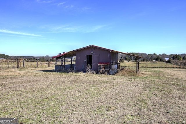 view of outbuilding featuring an outbuilding and a rural view