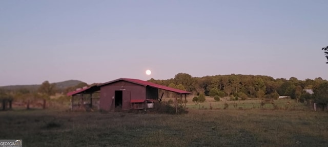 exterior space with an outdoor structure and a rural view