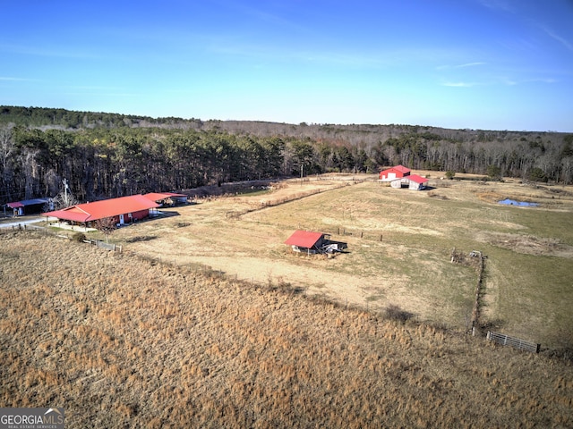 aerial view featuring a forest view and a rural view